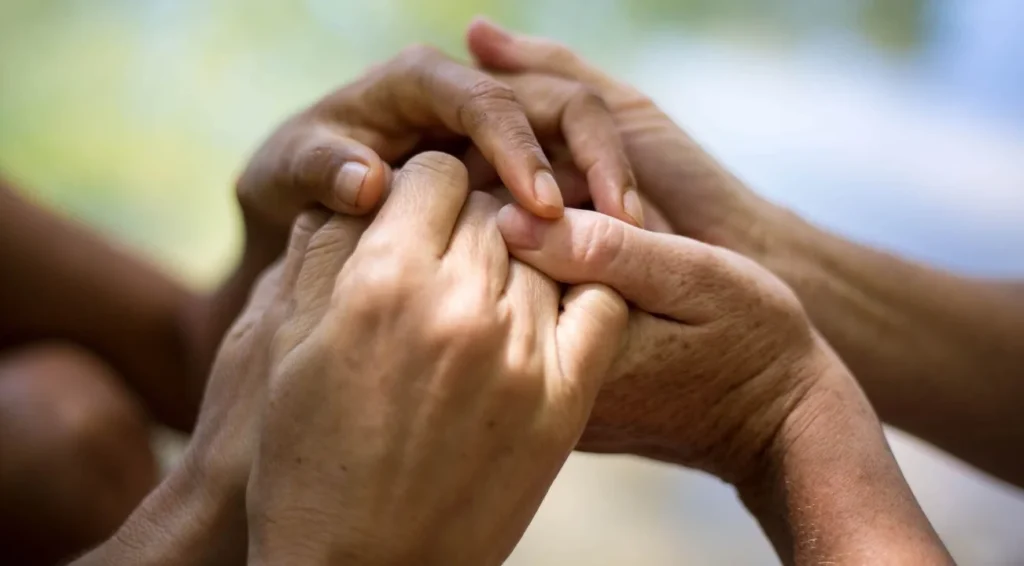 close up three holding hands looking at freedom