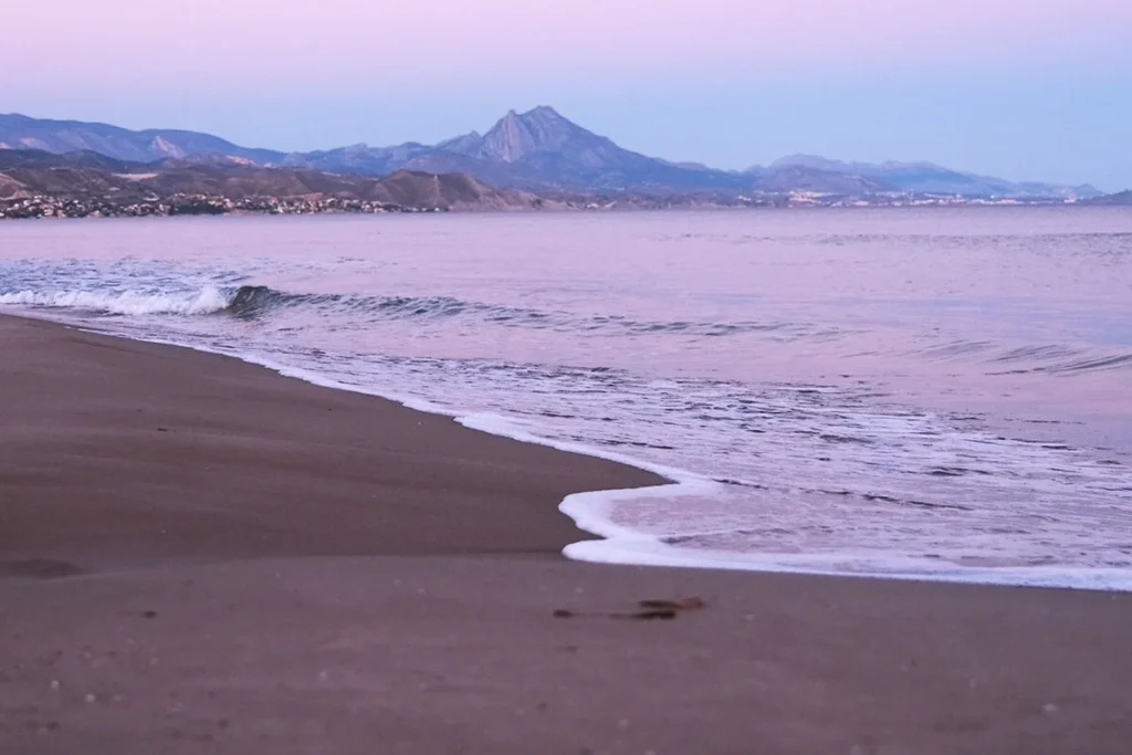 sunset by the beach and mountains in Alicante looking at freedom